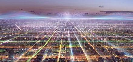 A panorama of a big city at night with a network of lights.