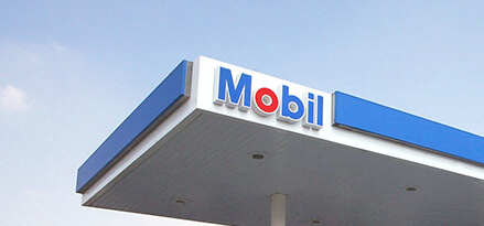 The roof of a Mobil station in front of a blue sky